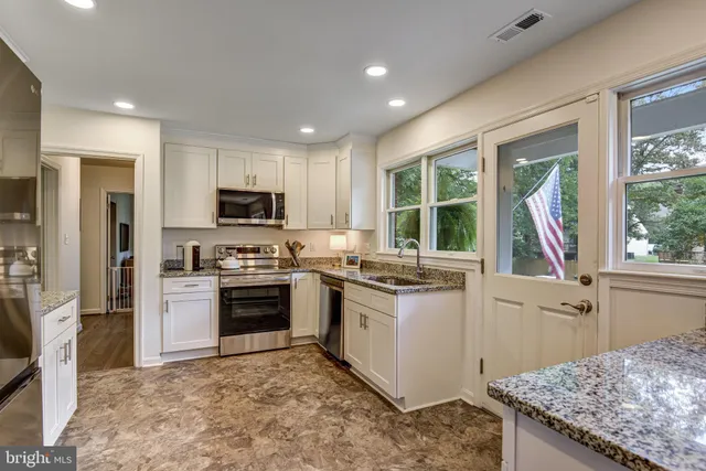 a kitchen with a stove a sink and a microwave