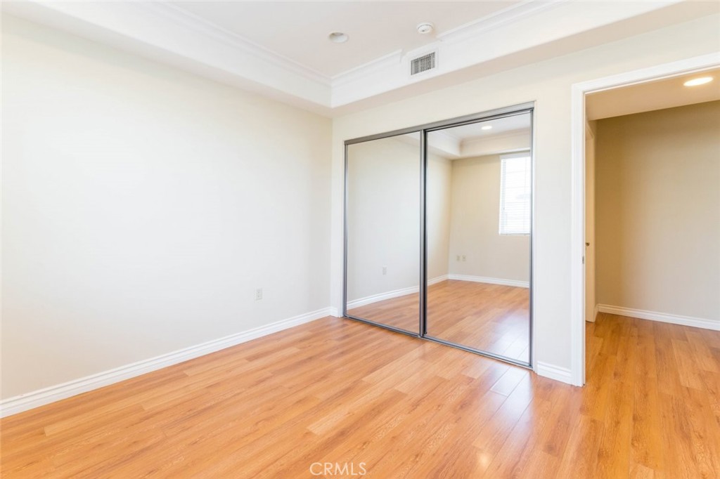 511 East Harvard Road, Unit 101 Burbank, CA 91501 - Photo 18 of 29 a view of empty room with wooden floor