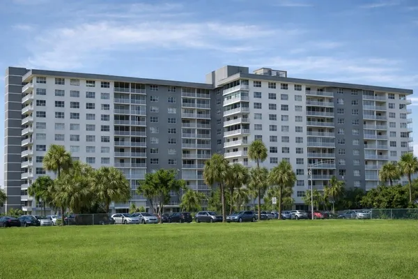 a front view of a building with a garden