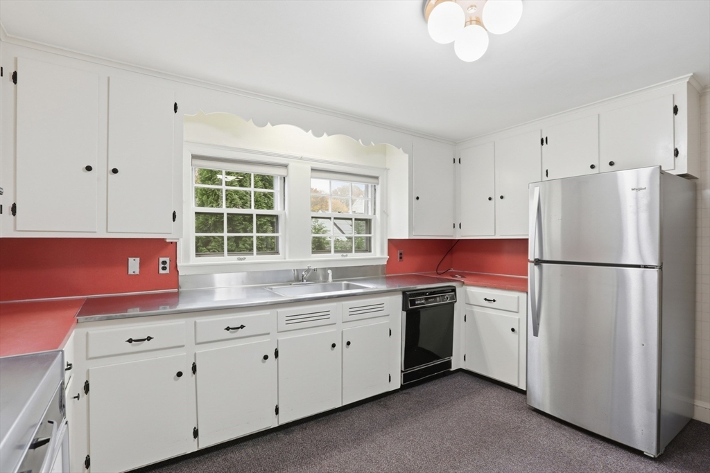12 Canterbury Road Winchester, MA 01890 - Photo 11 of 33 a kitchen with white cabinets and white appliances