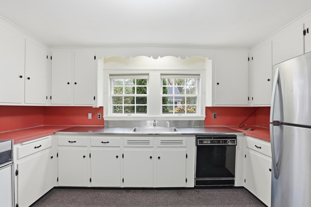 12 Canterbury Road Winchester, MA 01890 - Photo 12 of 33 a kitchen with granite countertop a sink cabinets stainless steel appliances and a window