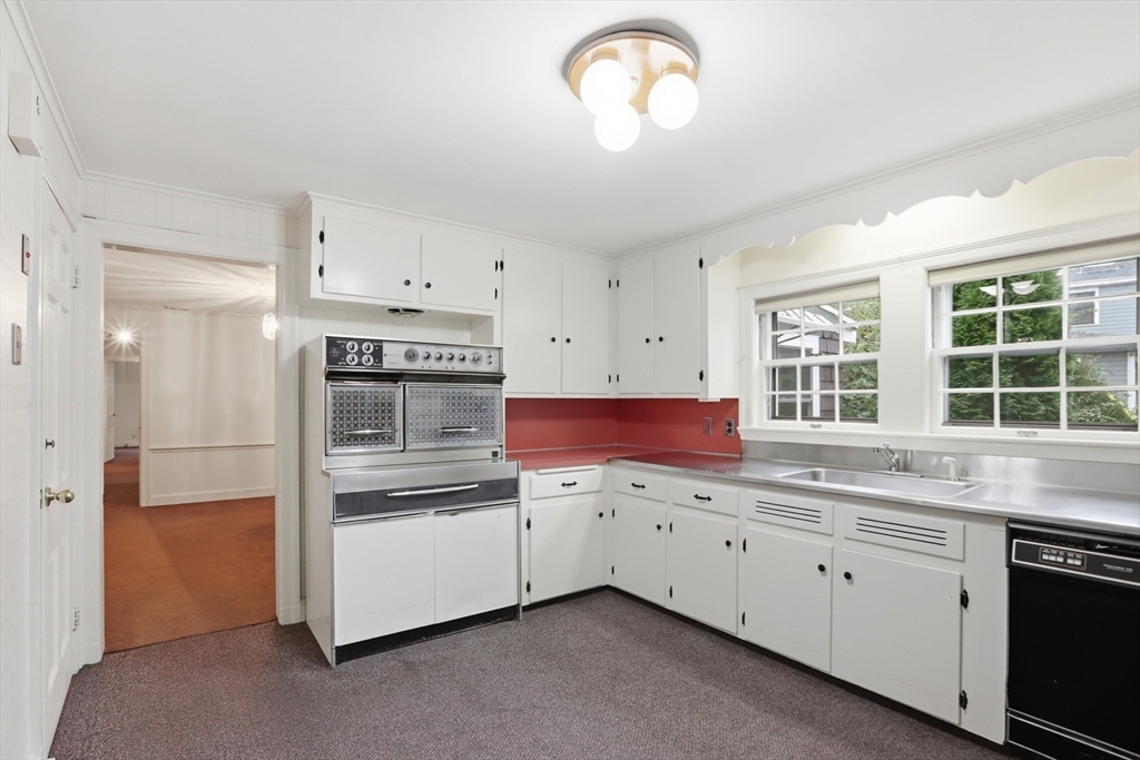 12 Canterbury Road Winchester, MA 01890 - Photo 13 of 33 a kitchen with a sink dishwasher a stove and a refrigerator