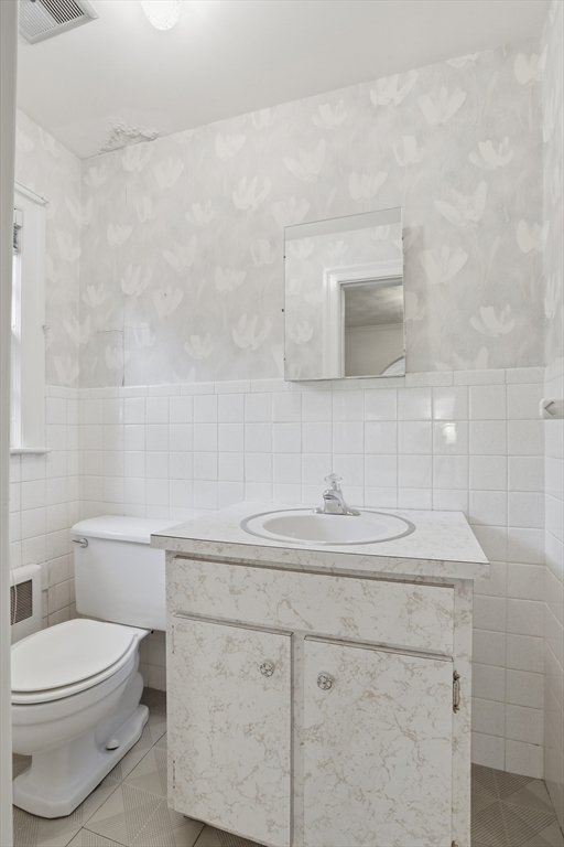 12 Canterbury Road Winchester, MA 01890 - Photo 18 of 33 a bathroom with a sink toilet and mirror