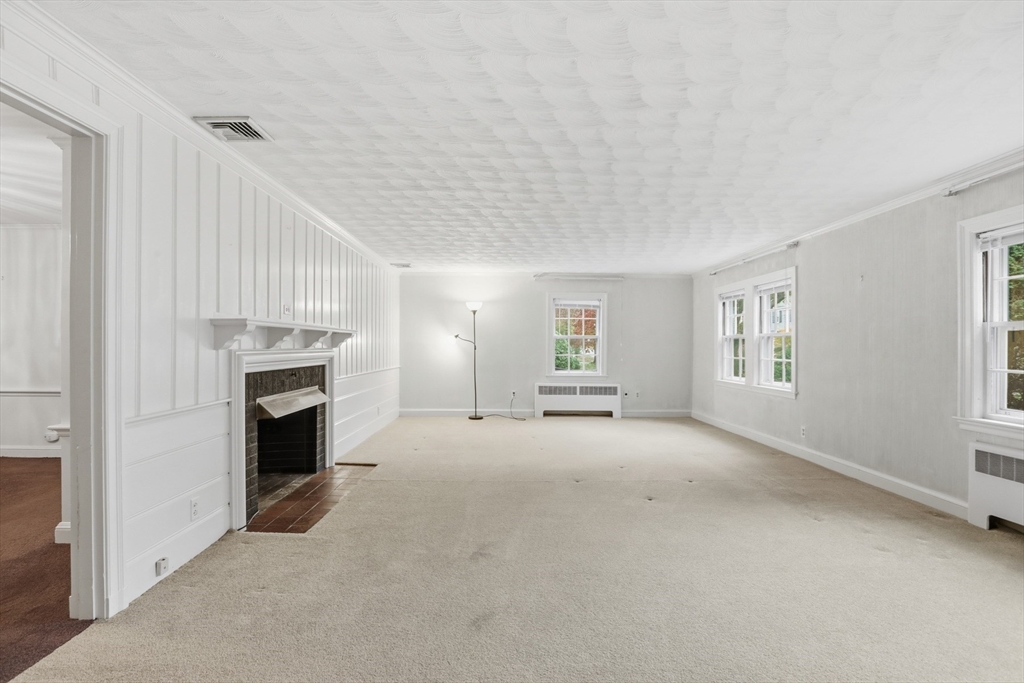 12 Canterbury Road Winchester, MA 01890 - Photo 7 of 33 a view of empty room with a fireplace and window