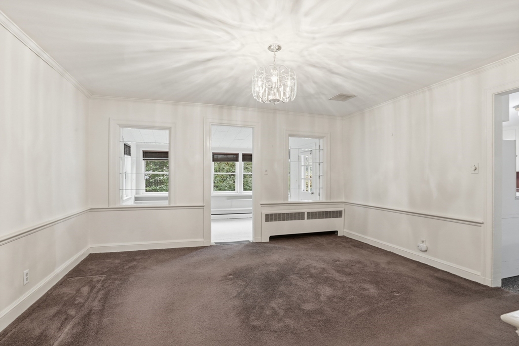 12 Canterbury Road Winchester, MA 01890 - Photo 10 of 33 wooden floor in an empty room with a window