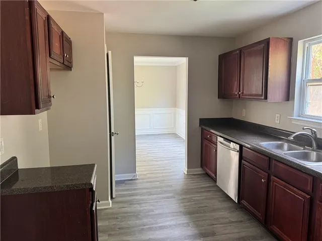 a kitchen with a sink and wooden cabinets