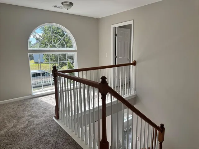 a view of an entryway with wooden floor