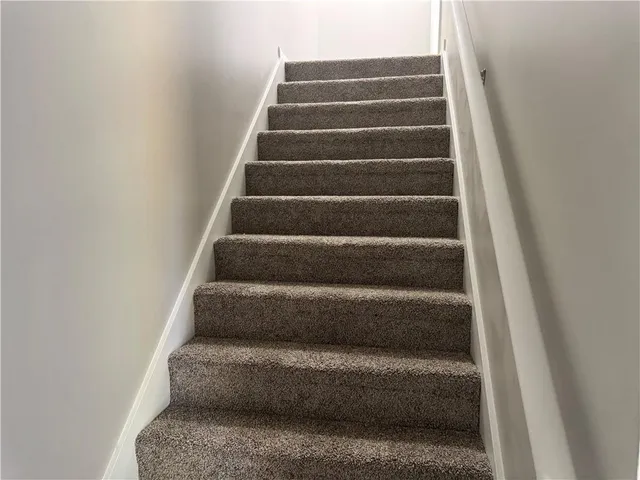 a view of staircase with white walls