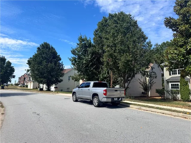 a view of street with parked cars
