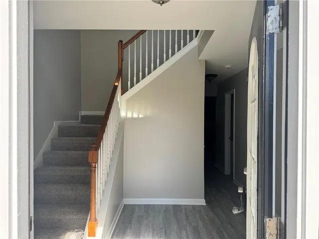 a view of entryway and hall with wooden floor