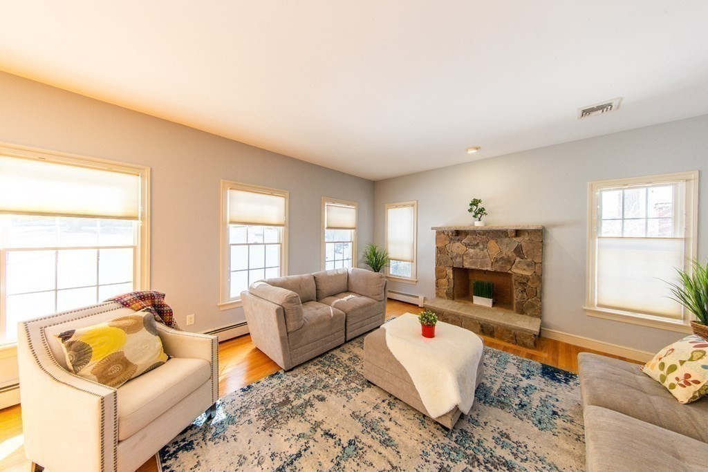 23 Pine Knoll Road Lexington, MA 02420 - Photo 12 of 42 a living room with furniture and a fireplace