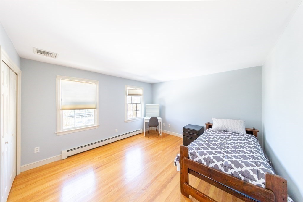 23 Pine Knoll Road Lexington, MA 02420 - Photo 25 of 42 a bedroom with a bed and wooden floor