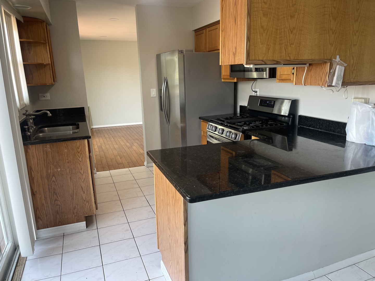 1964 Crescent Lane Hoffman Estates, IL 60169 - Photo 8 of 11 a kitchen with stainless steel appliances granite countertop a refrigerator and a stove