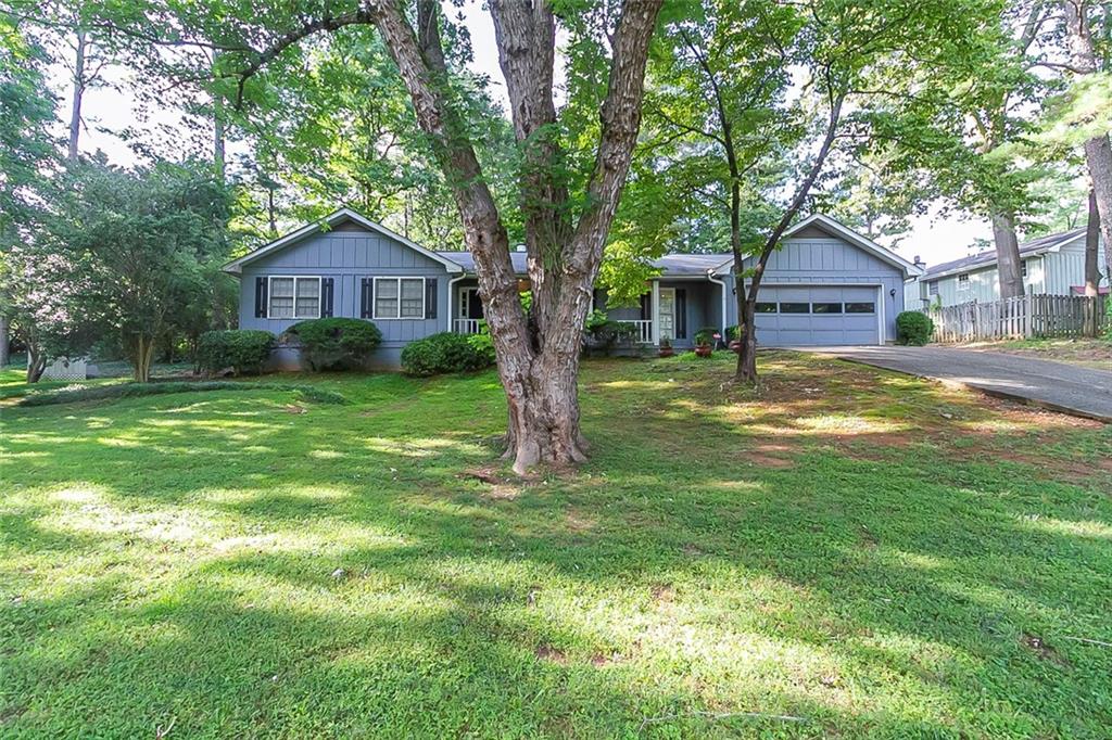 3009 Bunker Hill Road Marietta, GA 30062 - Photo 1 of 1 a front view of a house with yard and green space