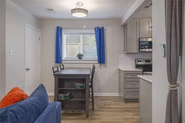 a kitchen with stainless steel appliances a sink a refrigerator and cabinets