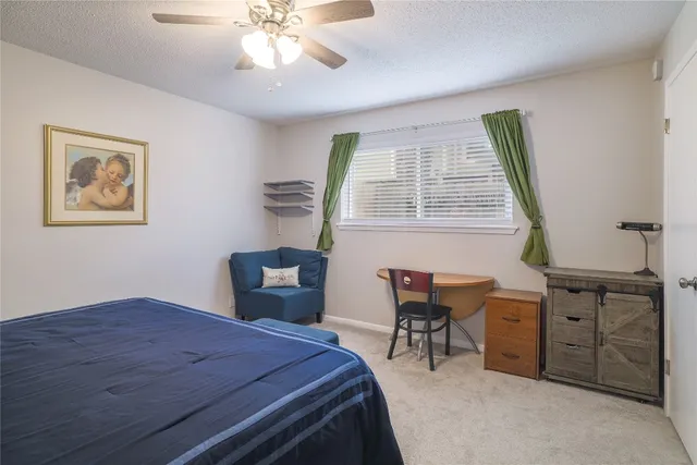 a bedroom with a bed and a desk