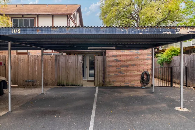 a side view of a backyard with table and chairs