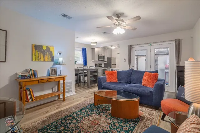 a living room with furniture and kitchen view
