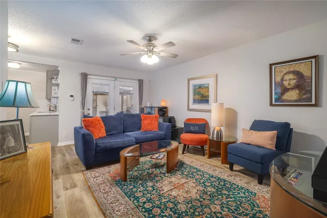 a living room with furniture and a chandelier