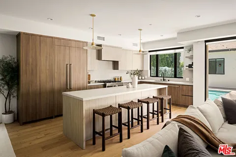 a kitchen with a table chairs and white cabinets