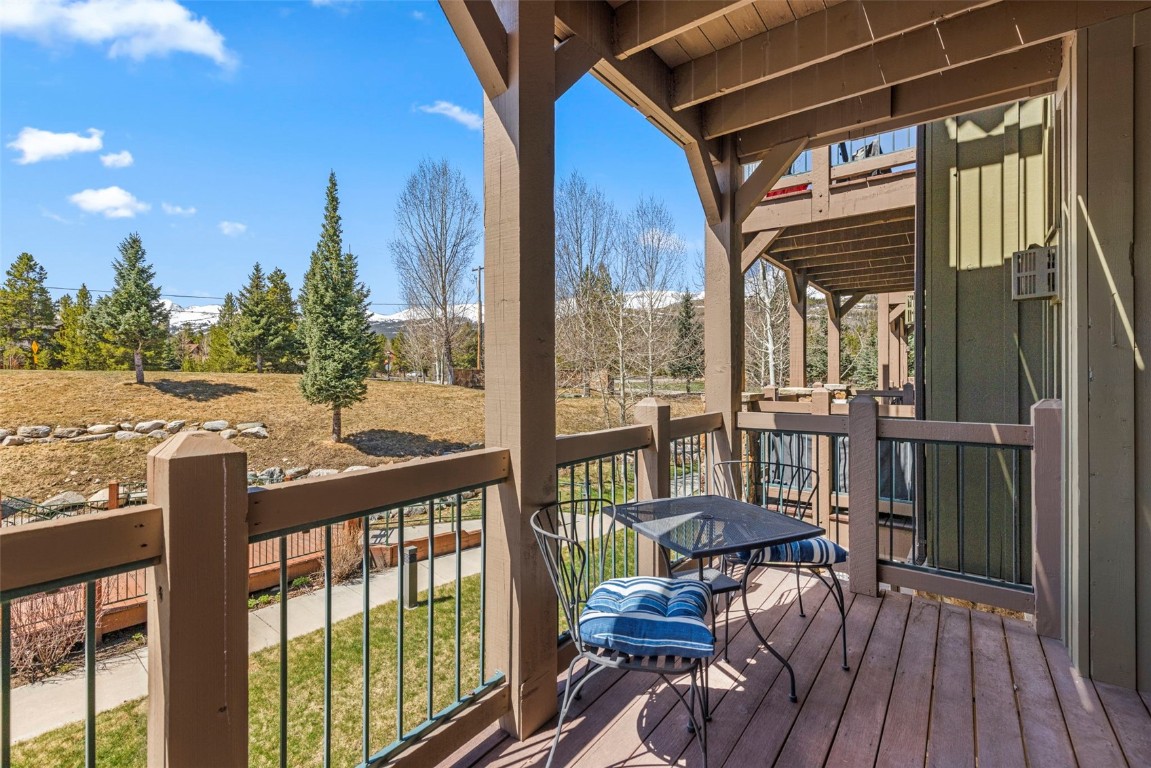 a view of a balcony with furniture and wooden floor