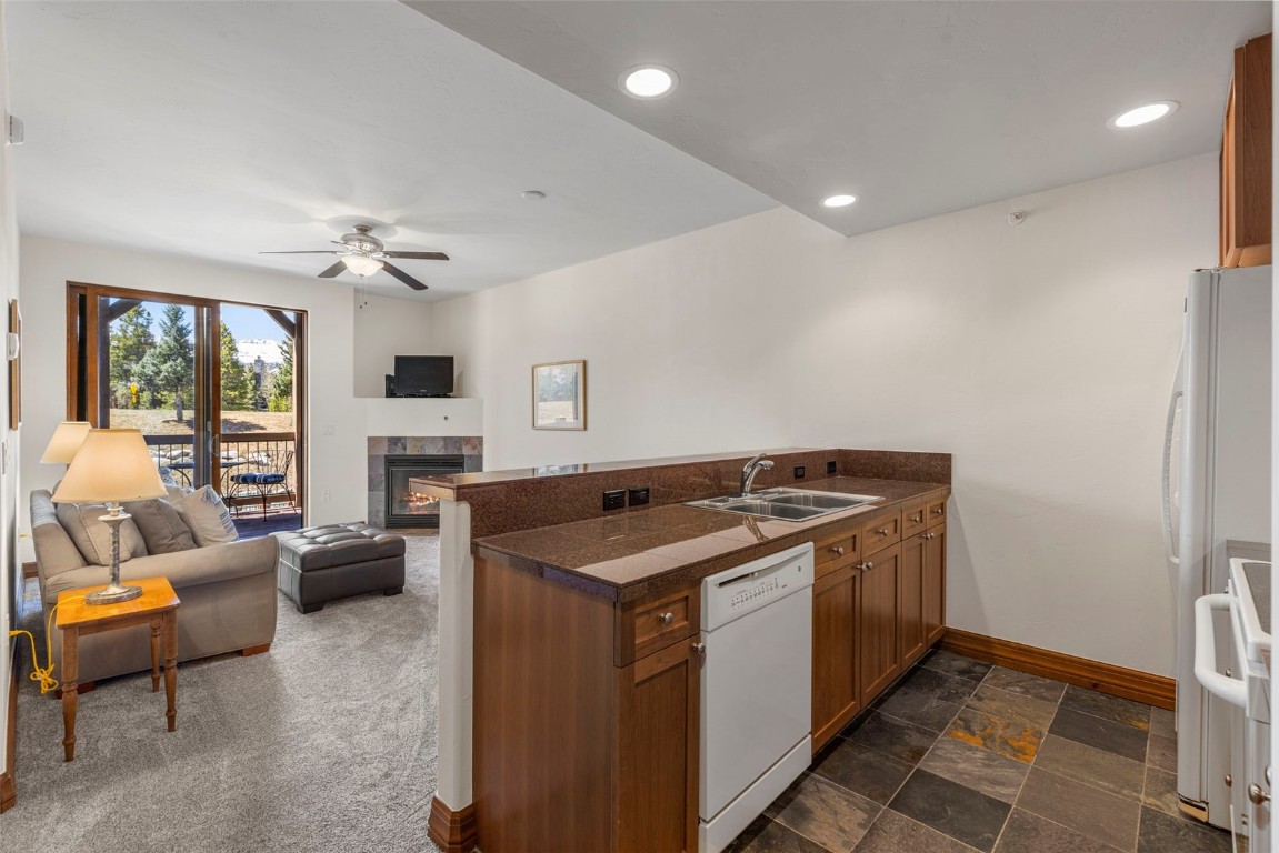 34 Highfield Trail, Unit 209 Breckenridge, CO 80424 - Photo 19 of 24 a kitchen with stainless steel appliances granite countertop a stove and a view of living room