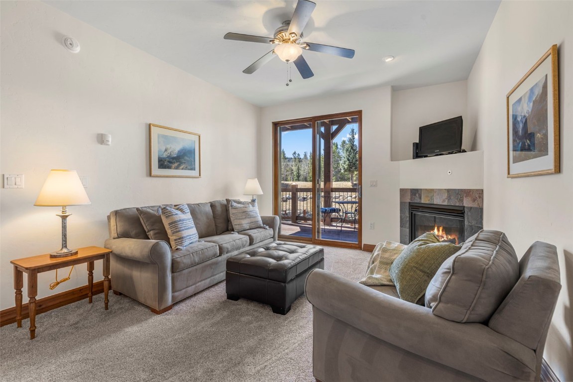 34 Highfield Trail, Unit 209 Breckenridge, CO 80424 - Photo 3 of 24 a living room with furniture a flat screen tv and a fireplace