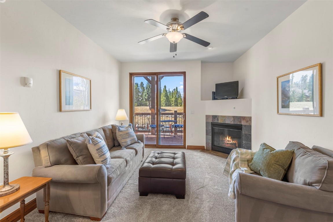 34 Highfield Trail, Unit 209 Breckenridge, CO 80424 - Photo 5 of 24 a living room with furniture a fireplace and a flat screen tv