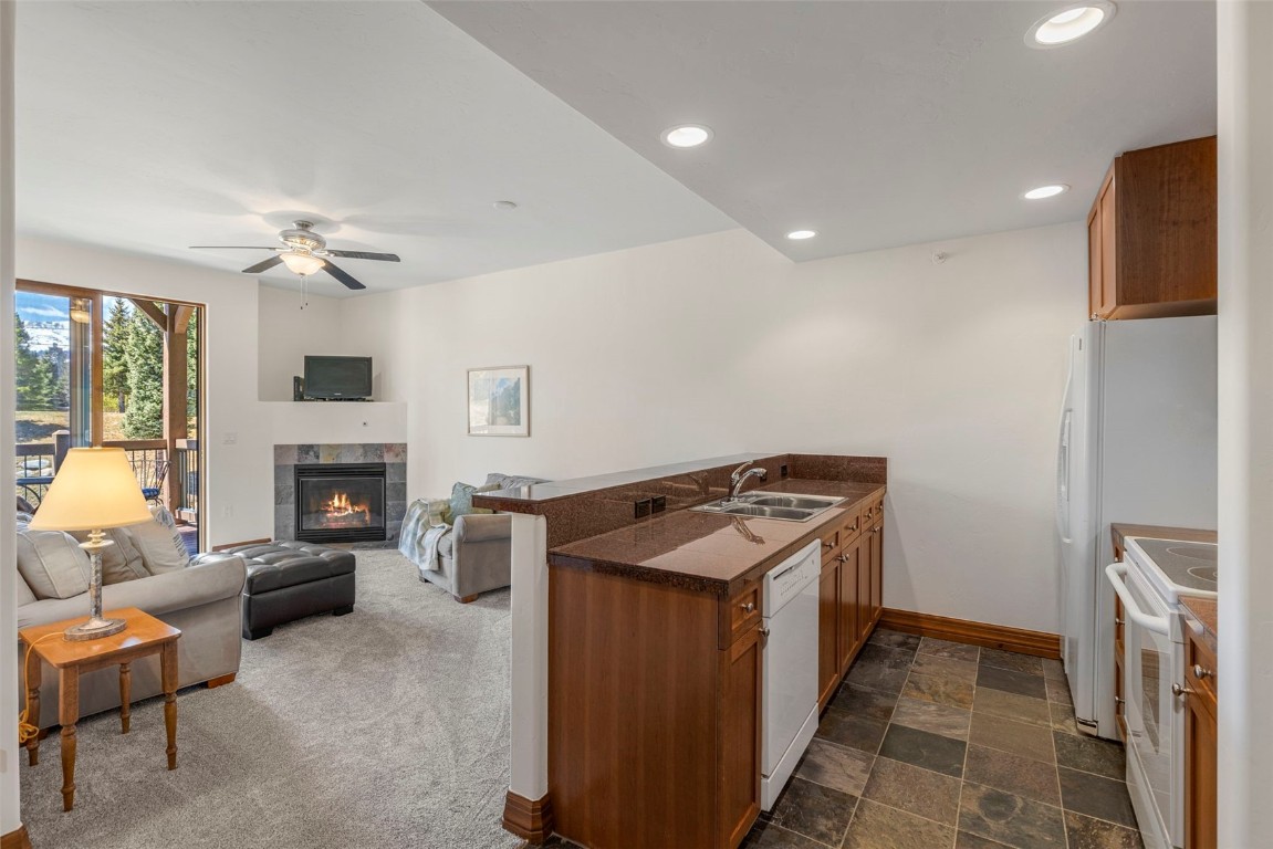 34 Highfield Trail, Unit 209 Breckenridge, CO 80424 - Photo 9 of 24 a kitchen with furniture and a fireplace