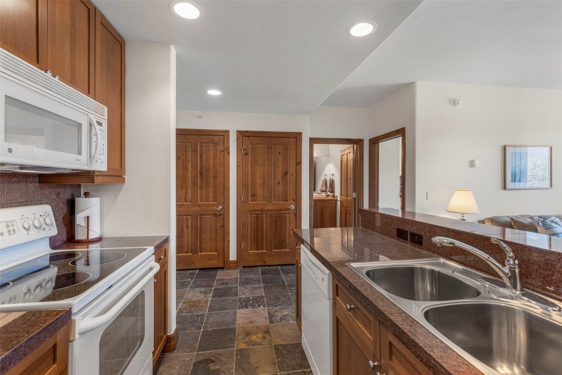34 Highfield Trail, Unit 209 Breckenridge, CO 80424 - Photo 10 of 24 a kitchen with a sink and refrigerator