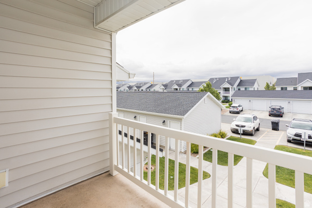 2452 West 500 South, Unit 2 Springville, UT 84663 - Photo 20 of 23 Outdoor balcony featuring a white railing, beige siding, and concrete flooring