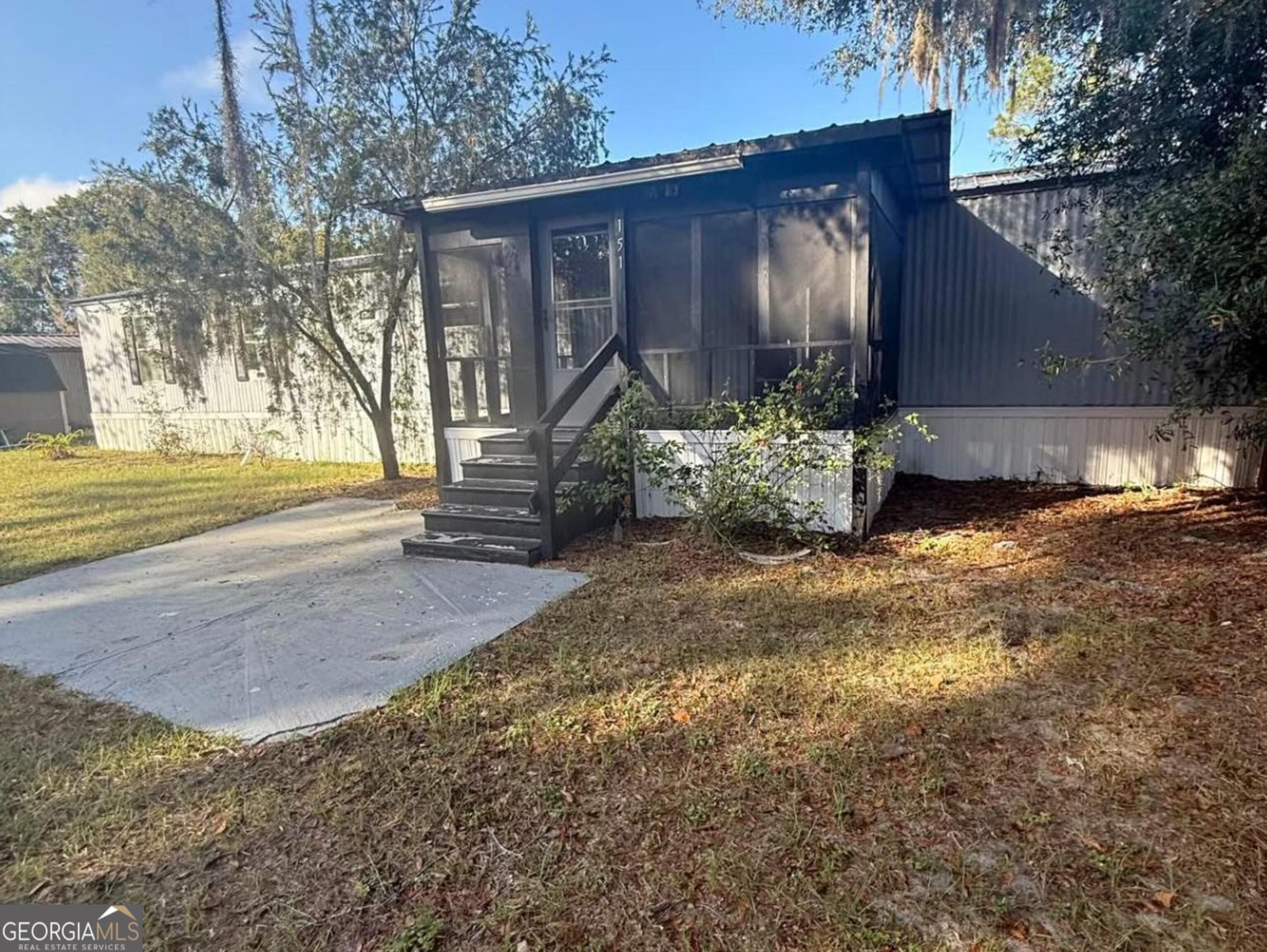 151 Ed Brown Street Folkston, GA 31537 - Photo 1 of 1 a view of a house with backyard and garden