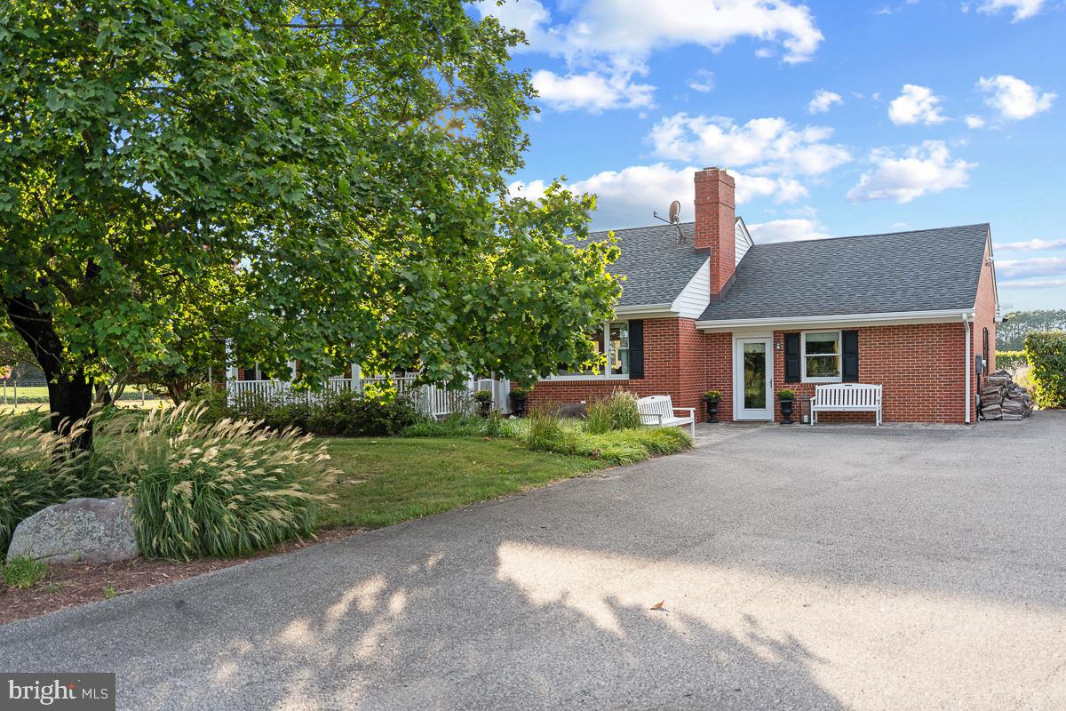 27772 Sharp Road Easton, MD 21601 - Photo 65 of 85 a front view of a house with a garden and plants