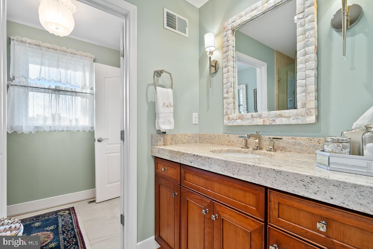 27772 Sharp Road Easton, MD 21601 - Photo 72 of 85 a bathroom with a granite countertop sink and a mirror