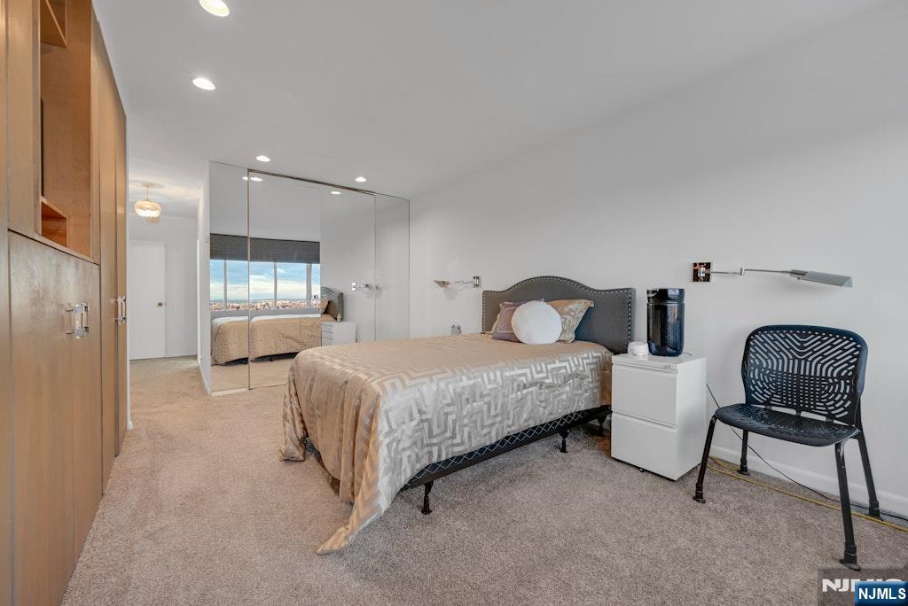 5 Horizon Road, Unit 2909 Fort Lee, NJ 07024 - Photo 13 of 29 a bedroom with bed and chair