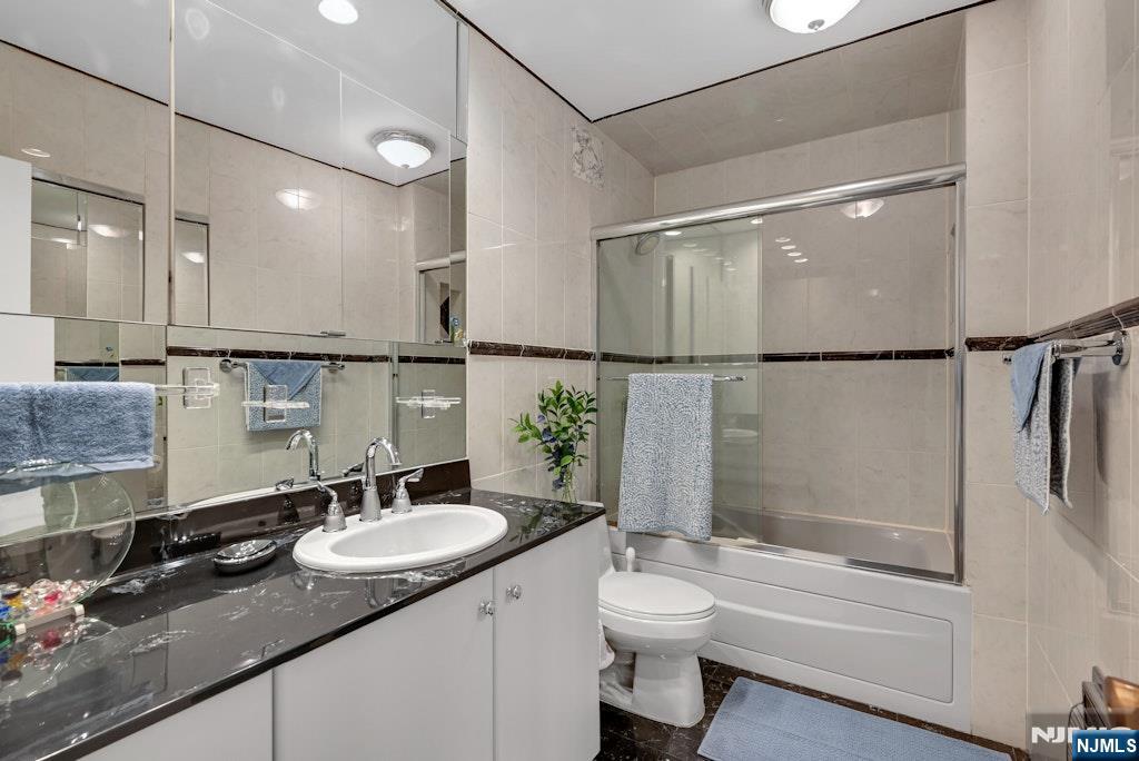 5 Horizon Road, Unit 2909 Fort Lee, NJ 07024 - Photo 18 of 29 a bathroom with a granite countertop sink toilet and shower