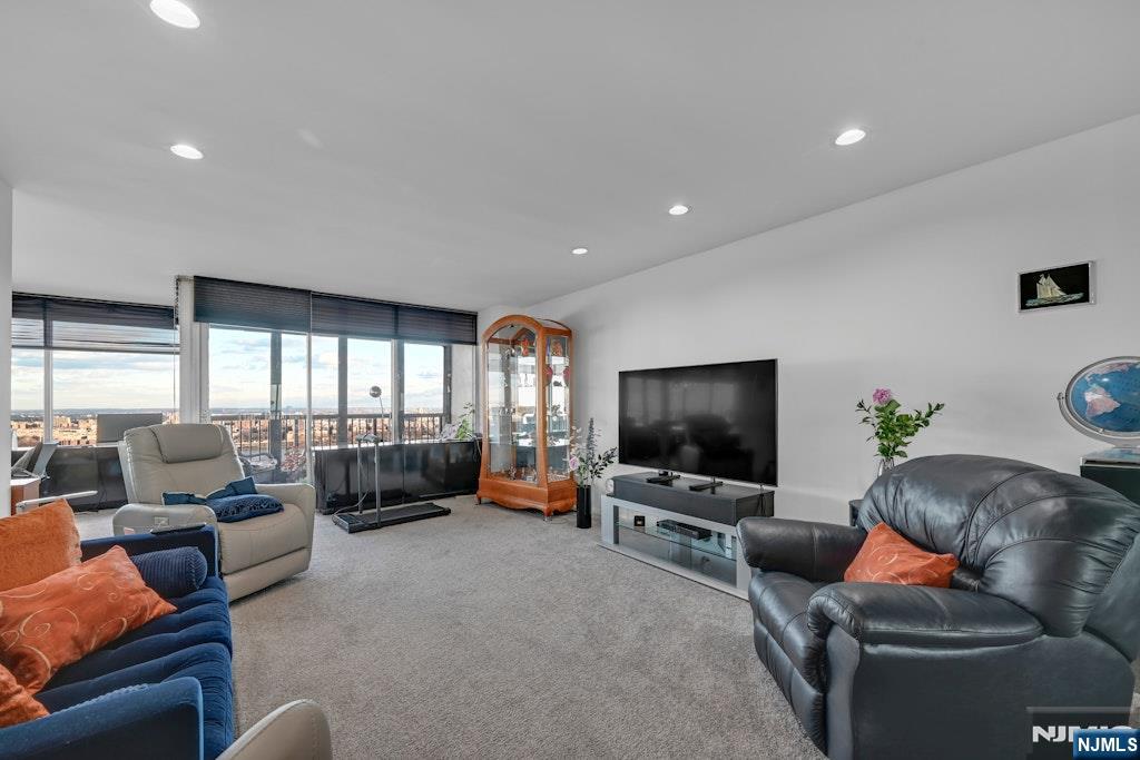 5 Horizon Road, Unit 2909 Fort Lee, NJ 07024 - Photo 6 of 29 a living room with furniture and a flat screen tv