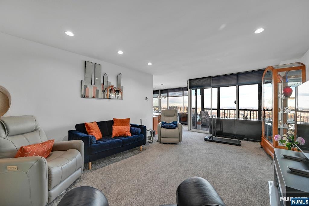 5 Horizon Road, Unit 2909 Fort Lee, NJ 07024 - Photo 9 of 29 a living room with furniture and a floor to ceiling window