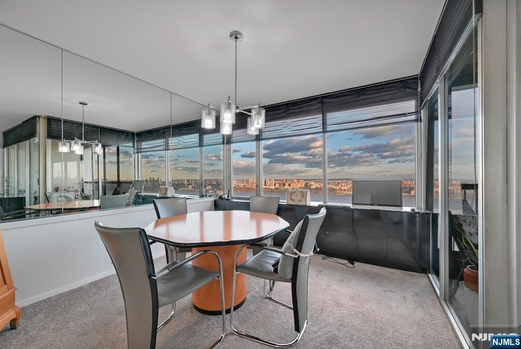5 Horizon Road, Unit 2909 Fort Lee, NJ 07024 - Photo 10 of 29 a dining room with furniture a chandelier and wooden floor