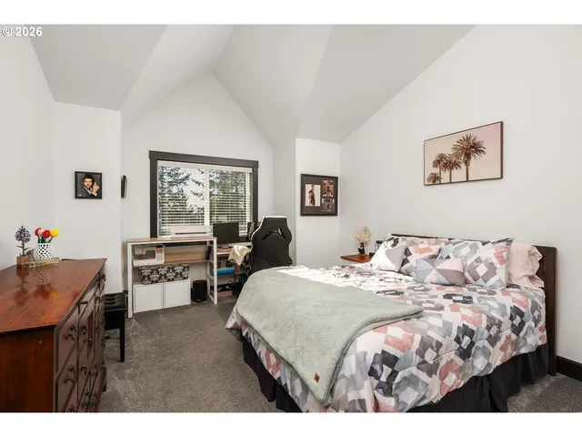 a bedroom with a bed and a table