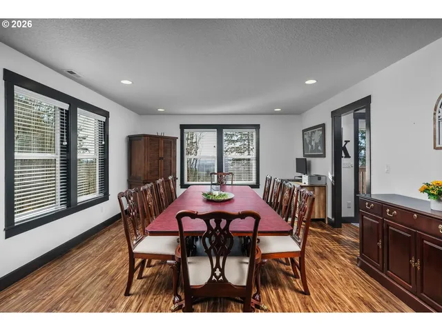 a view of a dining room with furniture and wooden floor