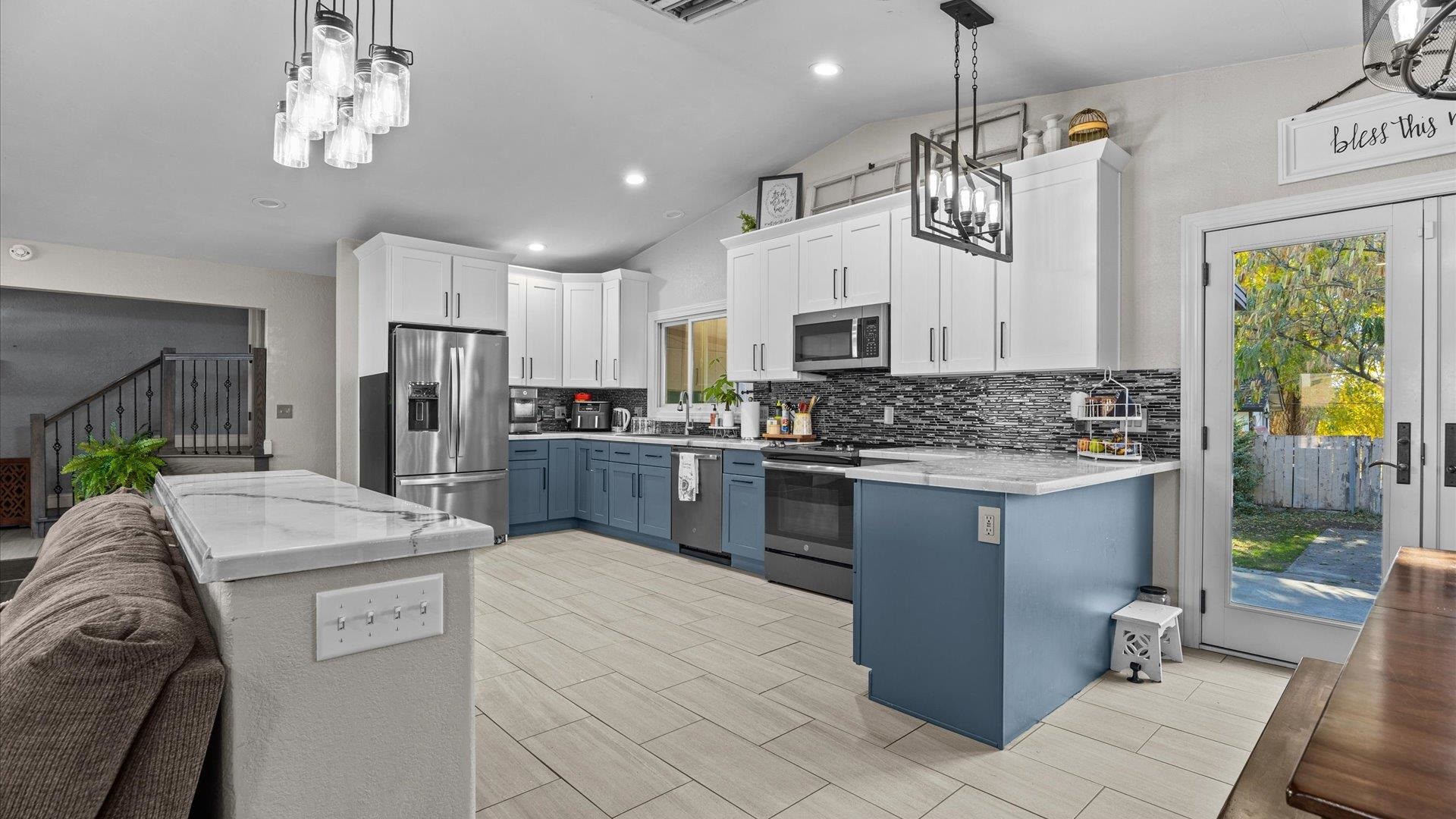 357 Music Lane Grand Junction, CO 81506 - Photo 12 of 29 a kitchen with stainless steel appliances kitchen island granite countertop a stove refrigerator and cabinets
