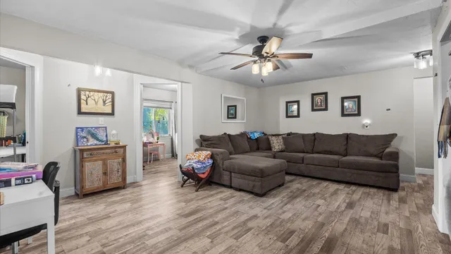 a living room with furniture and a wooden floor