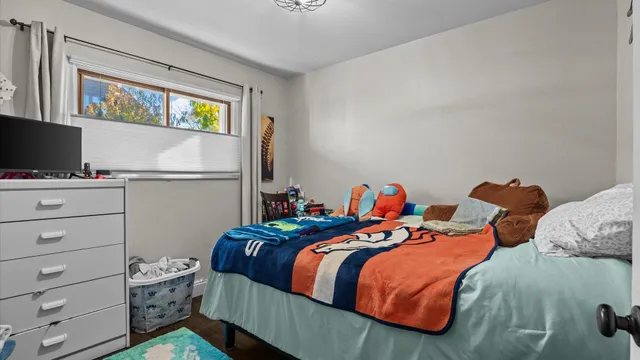 a bedroom with two beds and a window