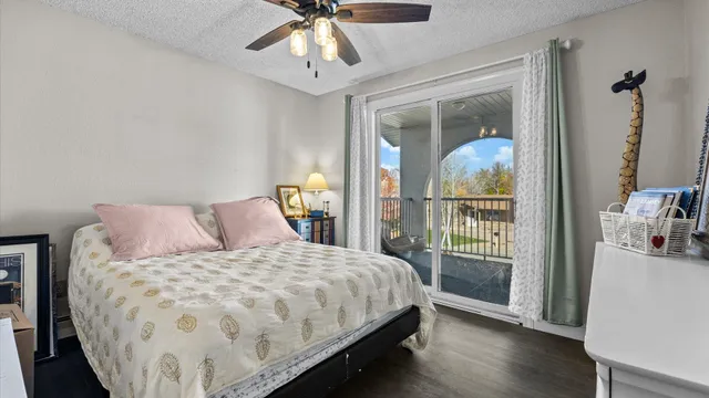 a bedroom with a large bed and a chandelier