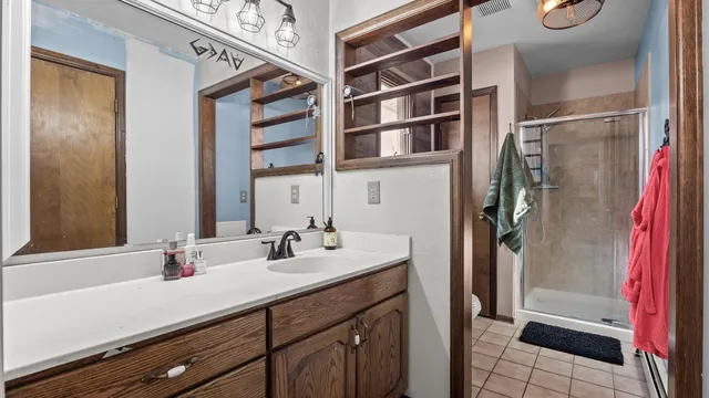 a bathroom with a double vanity sink a and a mirror