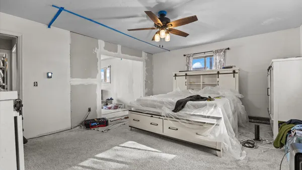a bedroom with a bed and a chandelier