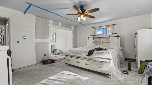 a bedroom with a bed and a chandelier