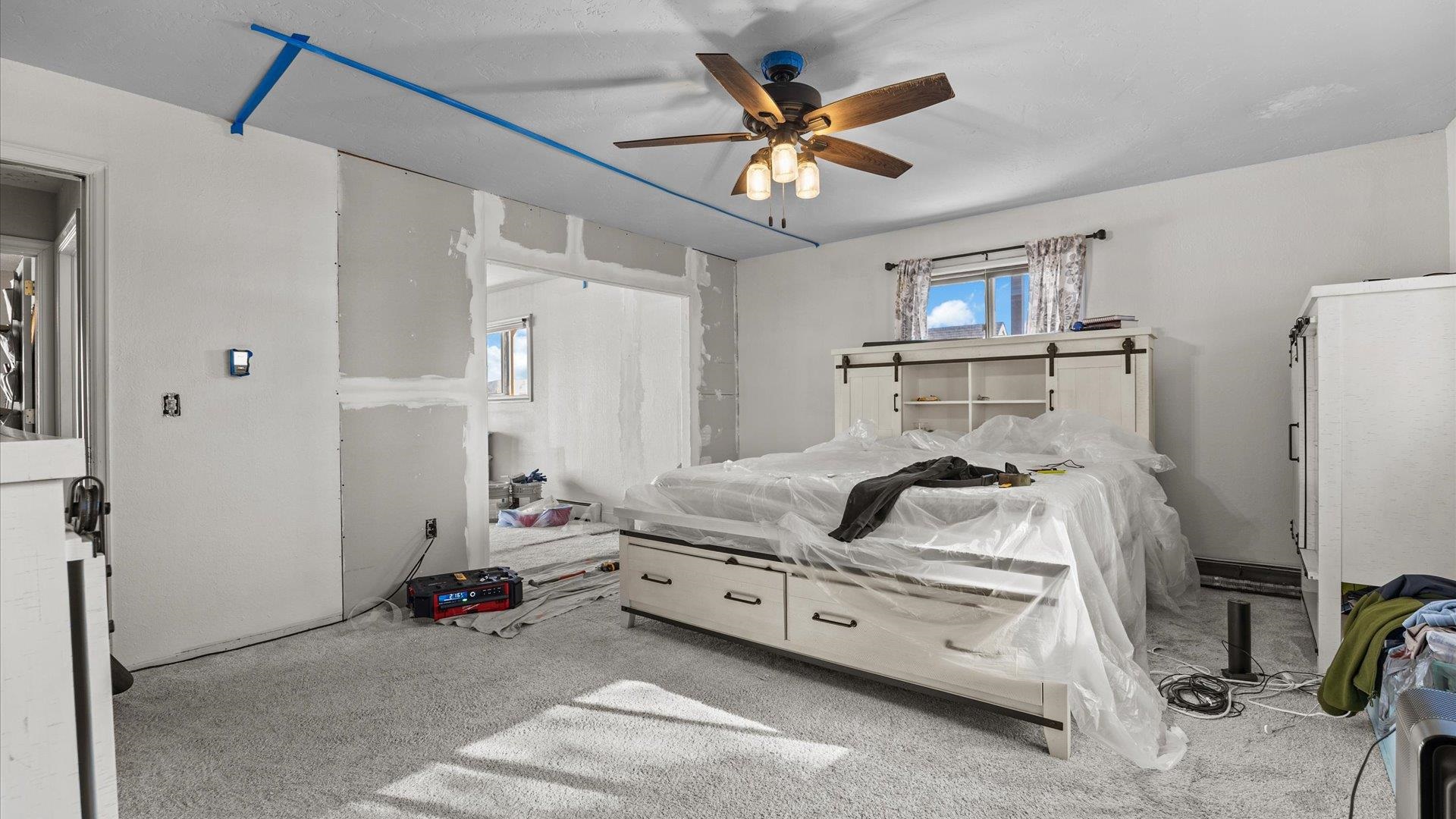 357 Music Lane Grand Junction, CO 81506 - Photo 23 of 29 a bedroom with a bed and a chandelier