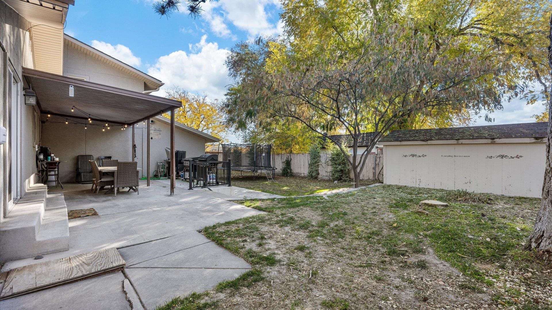 357 Music Lane Grand Junction, CO 81506 - Photo 28 of 29 a backyard of a house with table and chairs